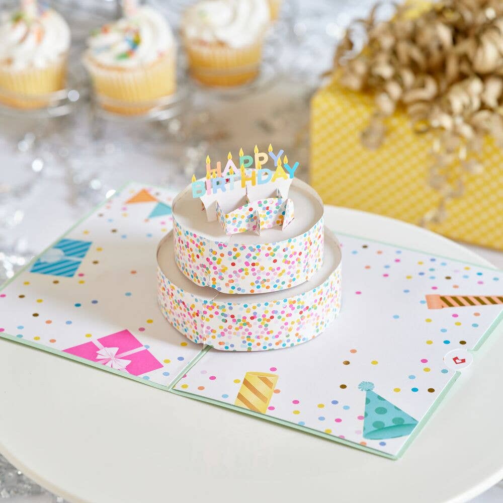 Pop-up birthday cake card displayed on a party table