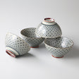Set of four ceramic bowls with geometric patterns on a white background