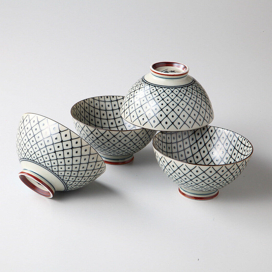 Set of four ceramic bowls with geometric patterns on a white background