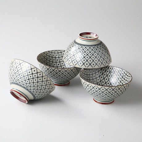 Set of four ceramic bowls with geometric patterns on a white background