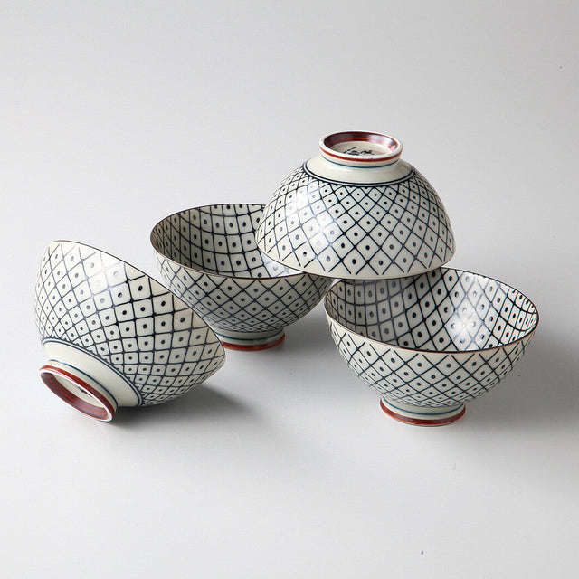 Set of four ceramic bowls with geometric patterns on a white background