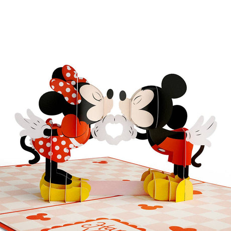 Mickey and Minnie sharing a kiss in a paper pop-up scene