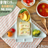 Children's lunch set with sandwich, vegetables, and soup on a wooden table.