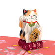 Smiling lucky cat pop-up sculpture with raised paw