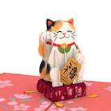 Smiling lucky cat pop-up sculpture with raised paw